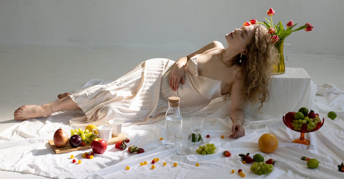 Regarding grace periods following an OPT extension (USA) [closed] - Peaceful young elegant woman lying on floor near fruits scattered on white cloth