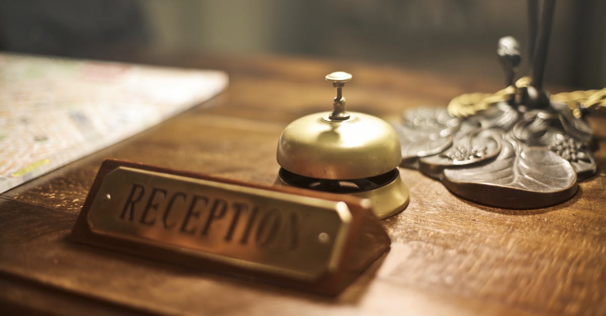 Registration in Russia on a 90 days business visa - Old fashioned golden service bell and reception sign placed on wooden counter of hotel with retro interior Registration in Russia on a 90 days business visa - Old fashioned golden service bell and reception sign placed on wooden counter of hotel with retro interior
