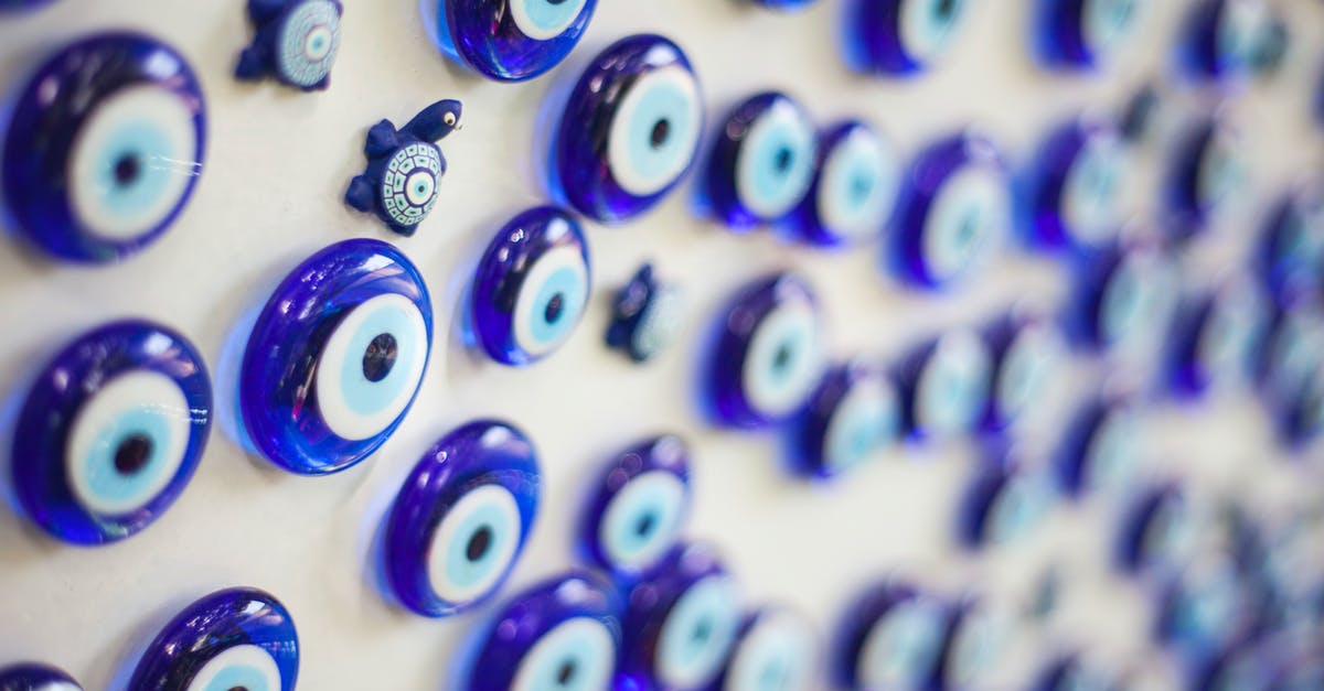Reinstate Known Traveller Number - Selective Focus Photography of Round Blue Gemstone Lot on White Surface