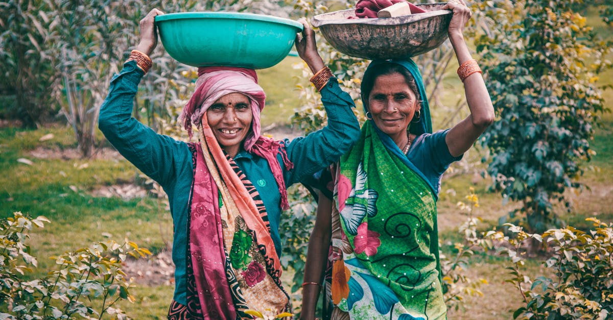 Renewing my Indian passport in India as an NRI - Two Women Wearing Traditional Dress Carrying Basins Renewing my Indian passport in India as an NRI - Two Women Wearing Traditional Dress Carrying Basins