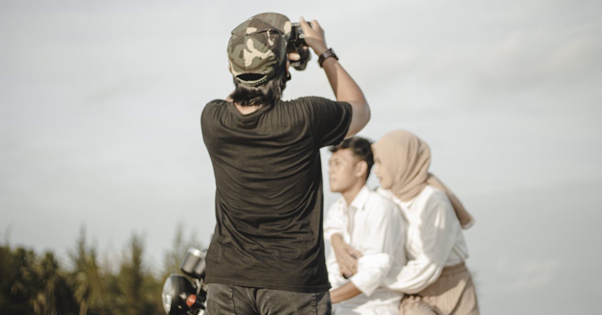 Rent a motorbike vs taking an organized ride/tour in Indonesia? [closed] - Back View of a Photographer Taking Picture of a Man and Woman Riding a Motorcycle
