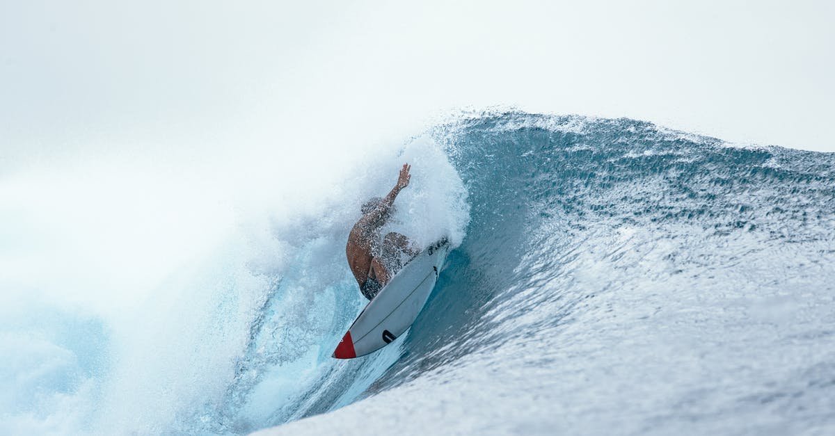 Rent a surf board for one month in Bali - Person riding on surfboard on wave Rent a surf board for one month in Bali - Person riding on surfboard on wave