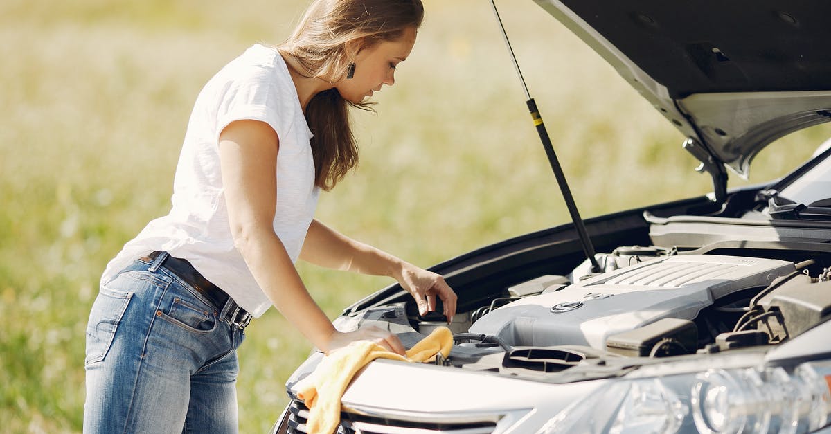 Rent car Green Card in Dubrovnik (Croatia) - Troubled young woman near broken automobile in countryside during car accident