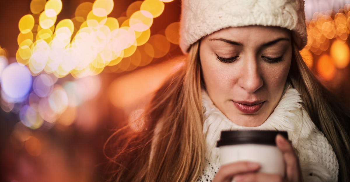 Rent clothing in Frankfurt / Being warm without cold weather clothing - Woman with takeaway hot drink on street in cold weather Rent clothing in Frankfurt / Being warm without cold weather clothing - Woman with takeaway hot drink on street in cold weather