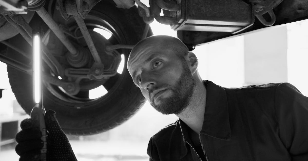 Renting a car in Israel when under 21? - Black and White Photo of a Mechanic Under a Car Renting a car in Israel when under 21? - Black and White Photo of a Mechanic Under a Car