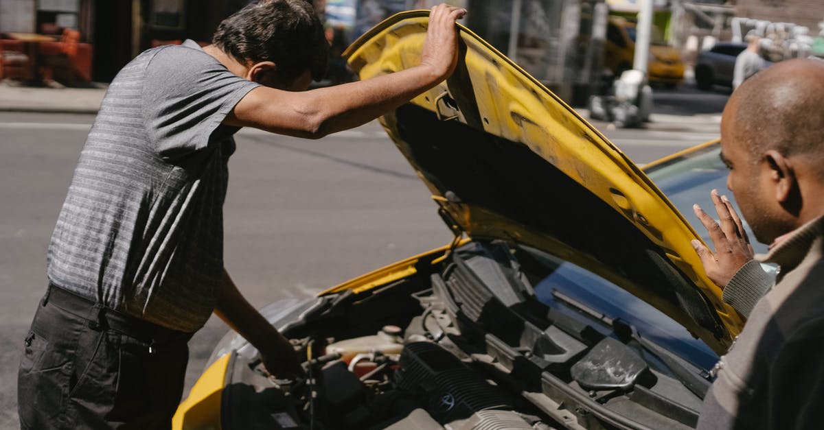 Renting a car with automatic transmission in Paris - Ethnic male drivers coping with trouble in car Renting a car with automatic transmission in Paris - Ethnic male drivers coping with trouble in car