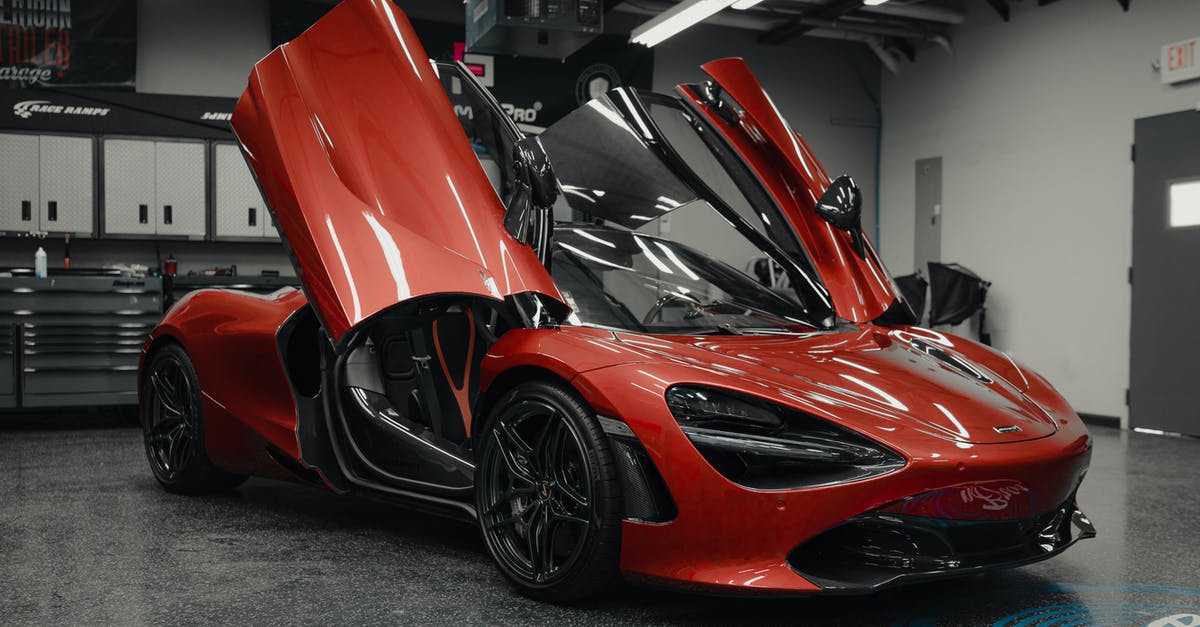 Renting a car with automatic transmission in Paris - Luxury sports red car in showing room Renting a car with automatic transmission in Paris - Luxury sports red car in showing room