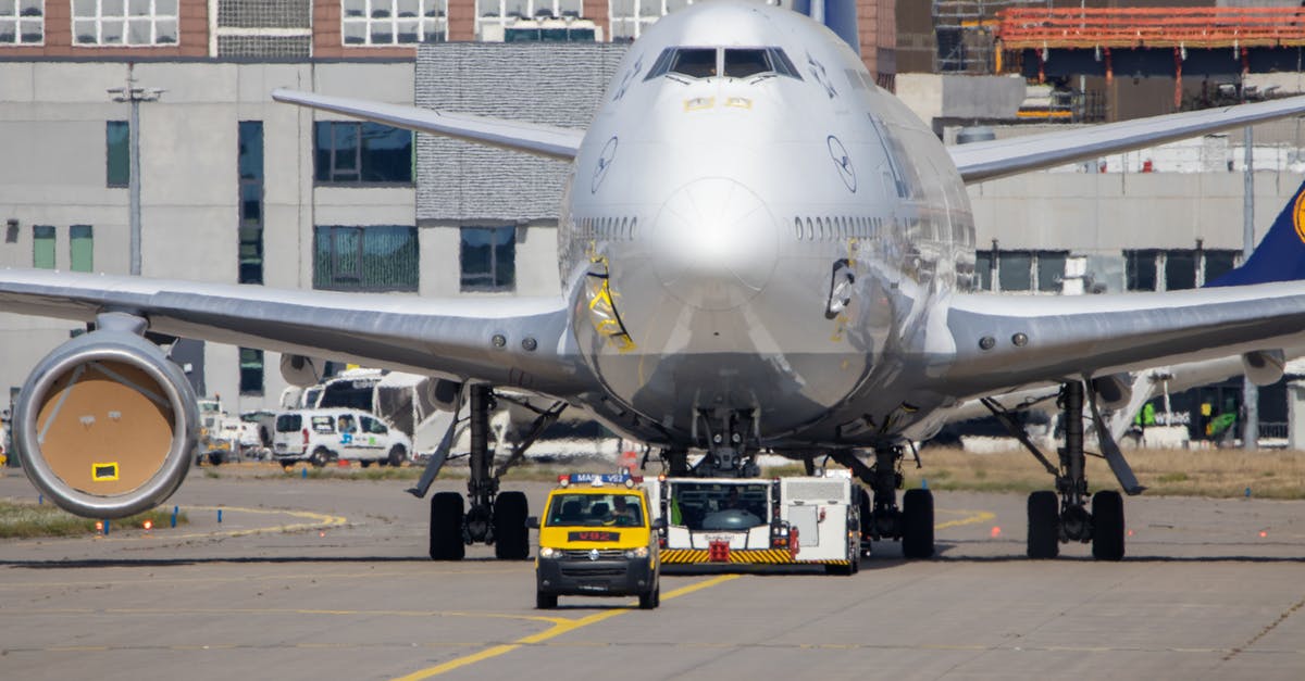 Renting a van out of Geneva airport - Photo of an Airplane Behind a Black and Yellow Van Renting a van out of Geneva airport - Photo of an Airplane Behind a Black and Yellow Van