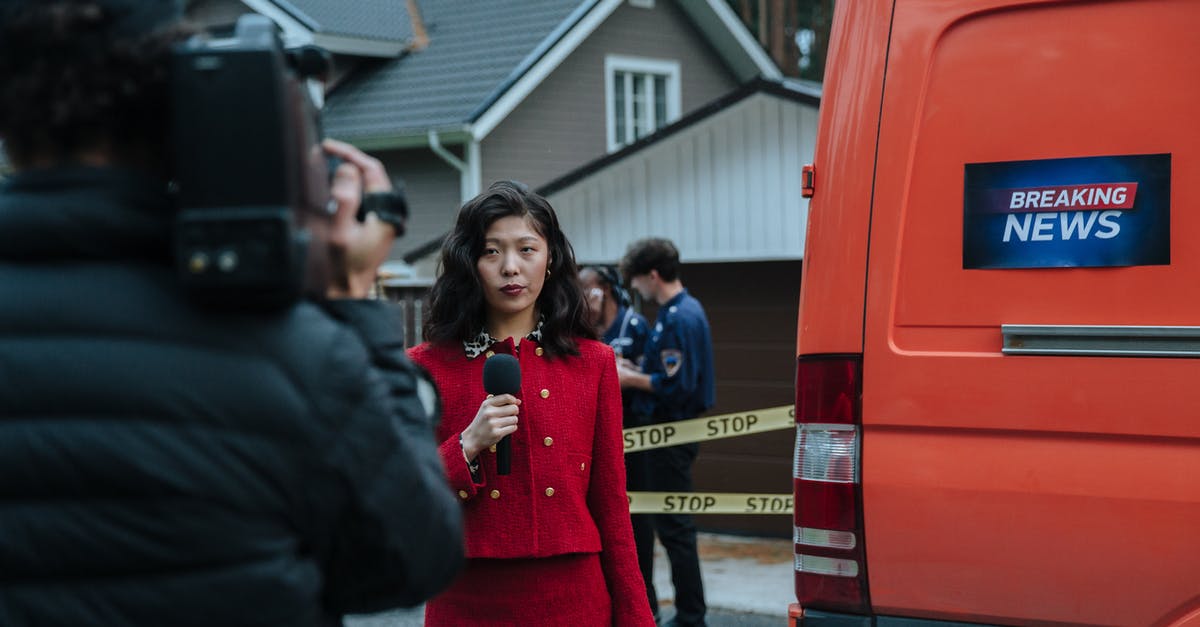 Reporting a cancelled visa - A Woman Reporting Beside The Van Reporting a cancelled visa - A Woman Reporting Beside The Van