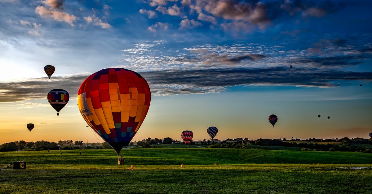 Reschedule a flight on Eva Air after original flight has departed [closed] - Assorted-color Hot Air Balloons on Grass Field during Golden Hour