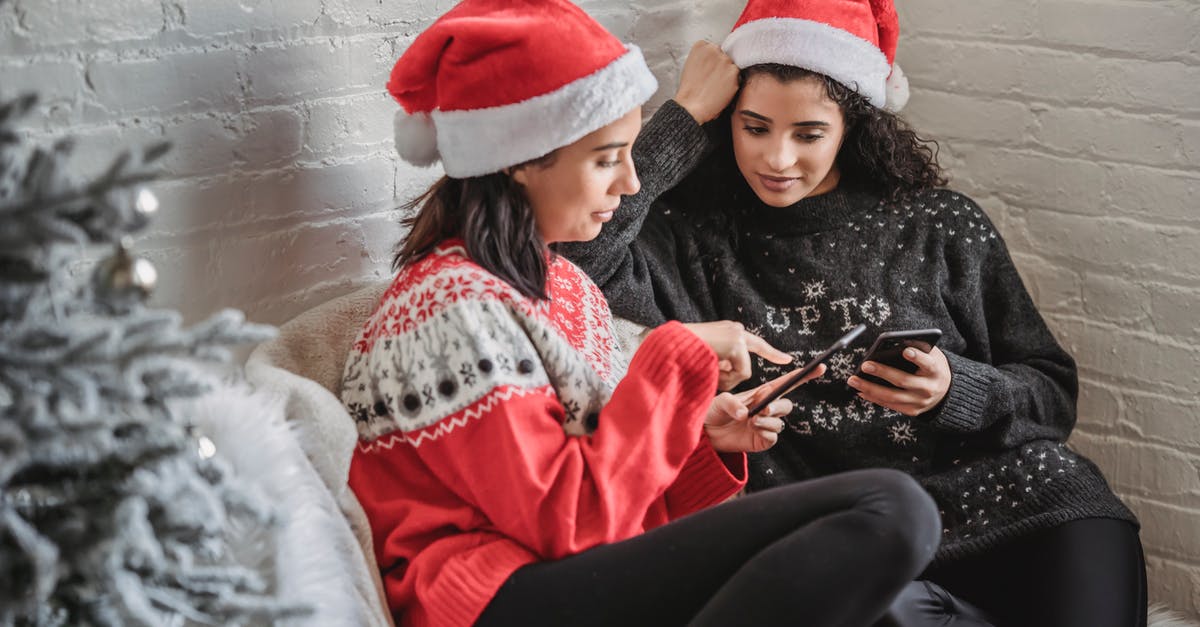 Returning to the US visa-free after previously living there for 7 years - issues with immigration? - Cheerful women watching video on smartphone sitting on sofa near Christmas tree in room Returning to the US visa-free after previously living there for 7 years - issues with immigration? - Cheerful women watching video on smartphone sitting on sofa near Christmas tree in room