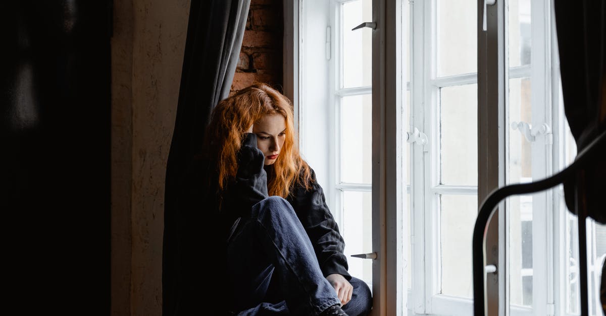 Re-visiting the UK alone with the EU national family visa - Woman in Black Leather Jacket Sitting on Brown Wooden Floor Re-visiting the UK alone with the EU national family visa - Woman in Black Leather Jacket Sitting on Brown Wooden Floor