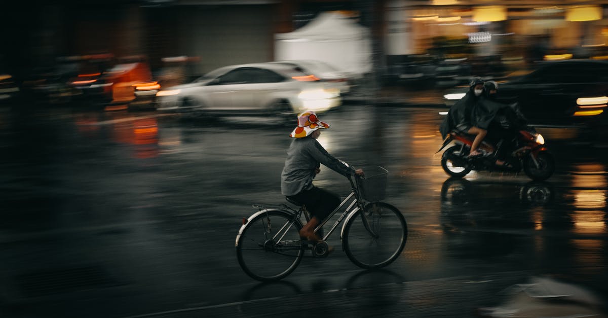 Riding an Abra at Night (Dubai) - A Person Riding a Bicycle while Wearing a Hat Riding an Abra at Night (Dubai) - A Person Riding a Bicycle while Wearing a Hat