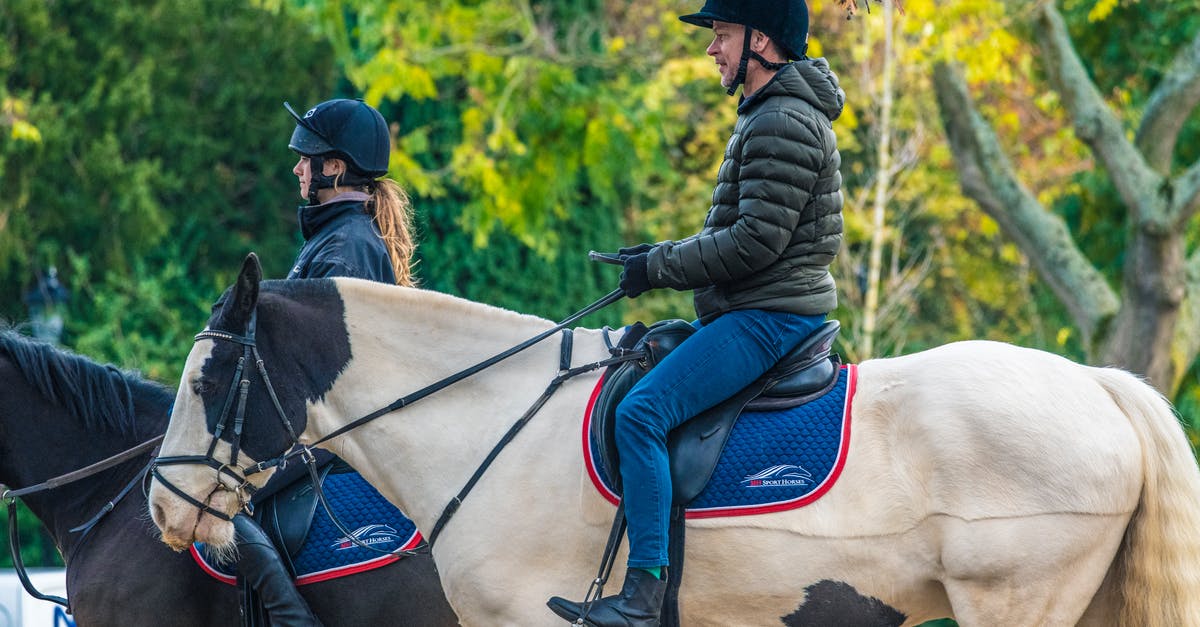 Riding on a narrowboat in London - Man and Woman Riding Horses Riding on a narrowboat in London - Man and Woman Riding Horses