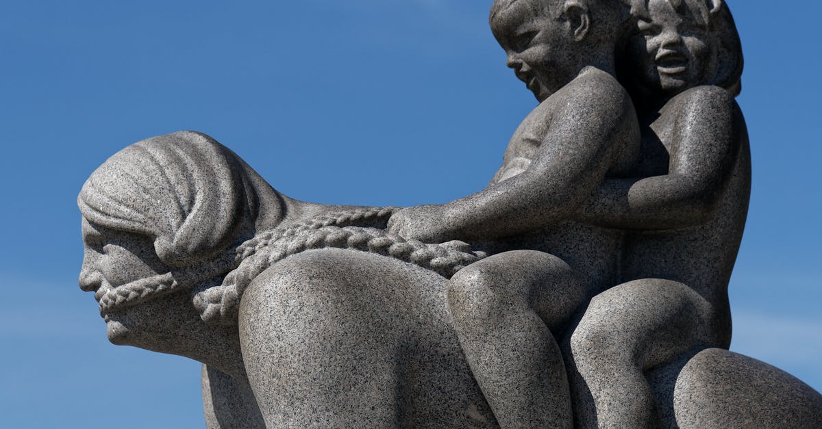 Riding the Paris Metro with a kid trailer - Gray Concrete Statue Under Blue Sky Riding the Paris Metro with a kid trailer - Gray Concrete Statue Under Blue Sky