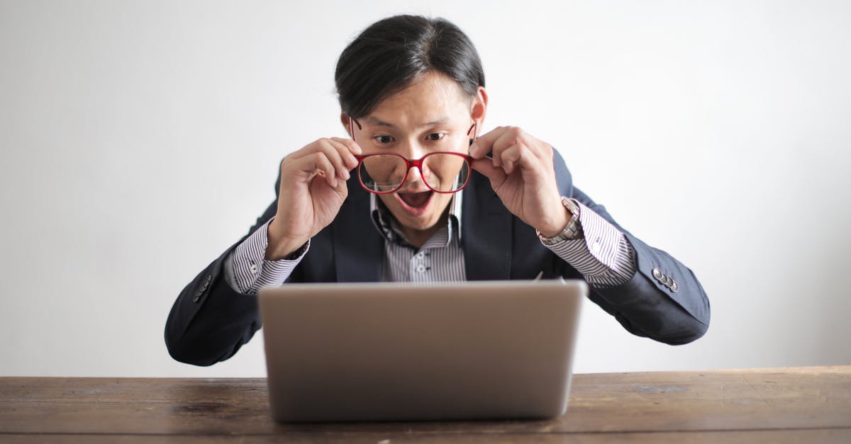 Risky Connection message - Amazed formal male looking at laptop screen Risky Connection message - Amazed formal male looking at laptop screen