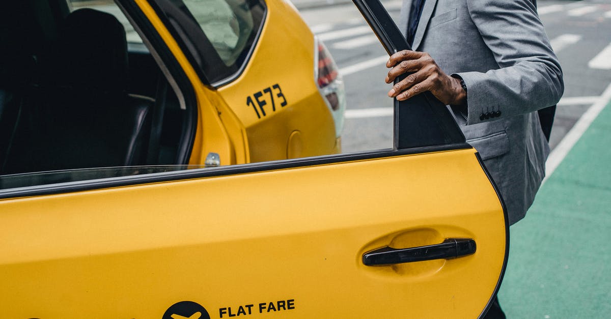 Roland-Garros (French Open) public viewing in Paris? - Side view crop anonymous African American male wearing classy jacket opening yellow taxi door parked on busy city street Roland-Garros (French Open) public viewing in Paris? - Side view crop anonymous African American male wearing classy jacket opening yellow taxi door parked on busy city street