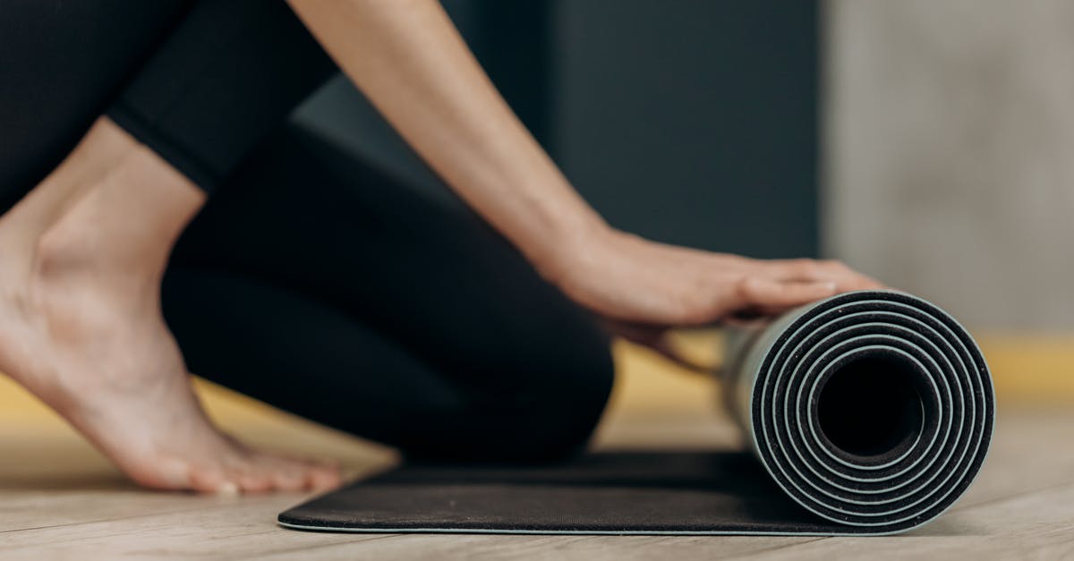 Rolling blackouts in the Philippines - Woman Rolling A Yoga Mat Rolling blackouts in the Philippines - Woman Rolling A Yoga Mat