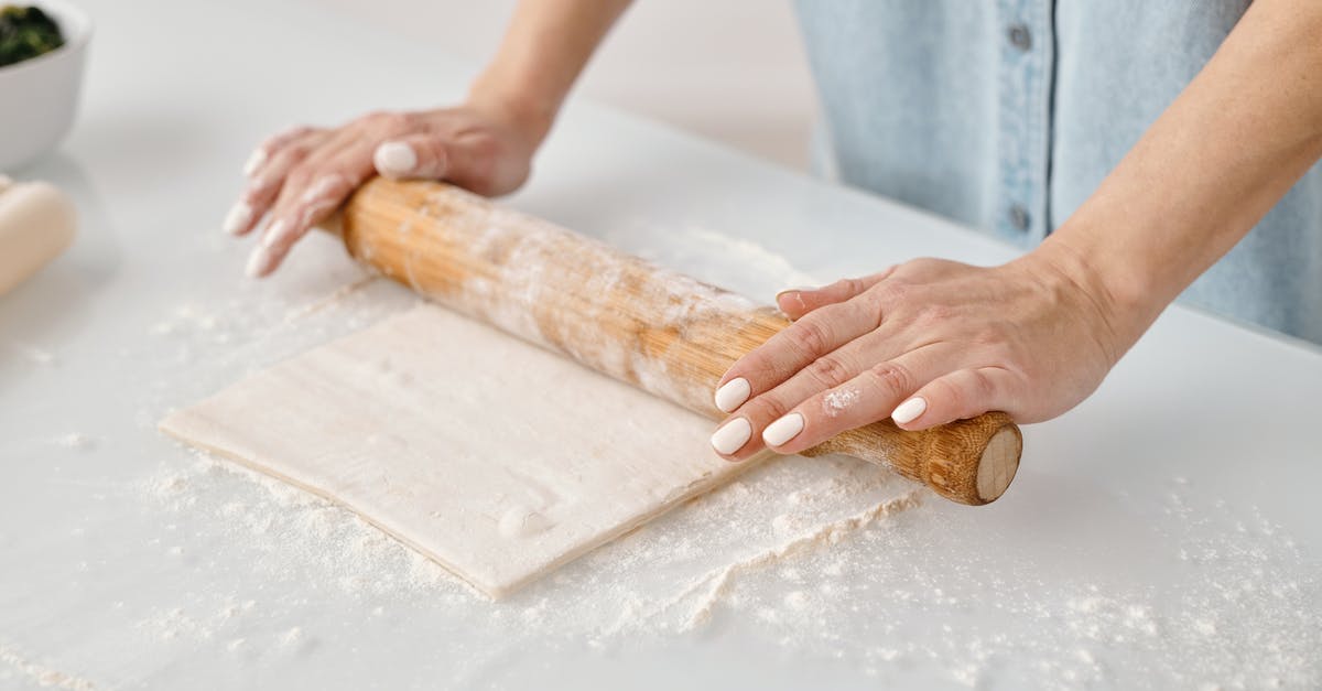 Rolling shirts in a bundle VS laying them flat while packing? - Person Flattening a Dough With Rolling Pin Rolling shirts in a bundle VS laying them flat while packing? - Person Flattening a Dough With Rolling Pin