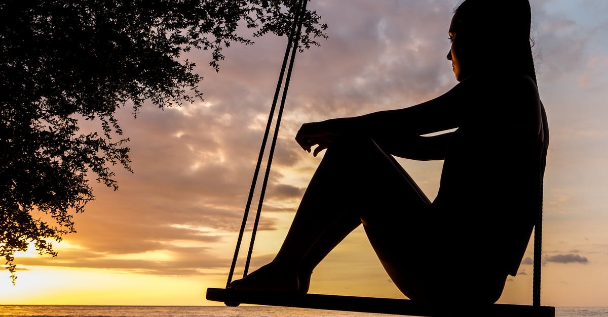 Round Trip cancel return for one person - Silhouette of Woman on Swing during Golden Hour Round Trip cancel return for one person - Silhouette of Woman on Swing during Golden Hour