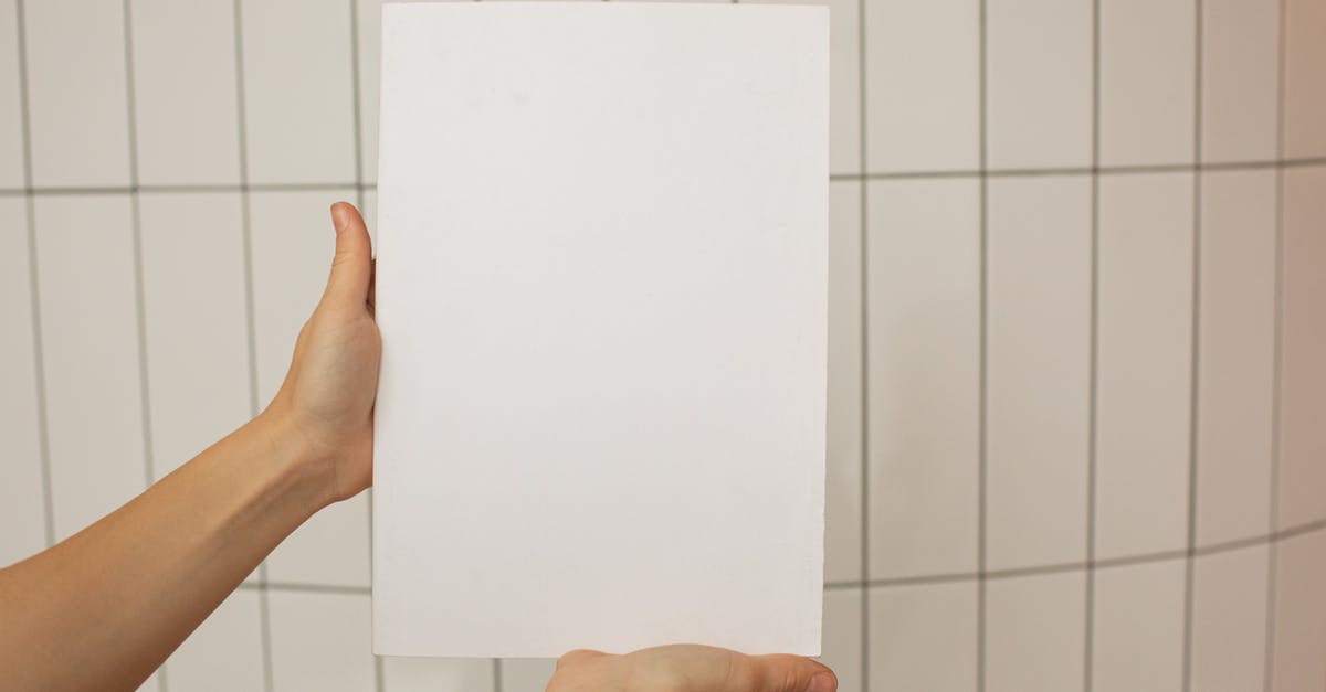 Russia roadmap with information on the surface - Crop faceless person showing empty sheet of paper with tiled wall on background Russia roadmap with information on the surface - Crop faceless person showing empty sheet of paper with tiled wall on background