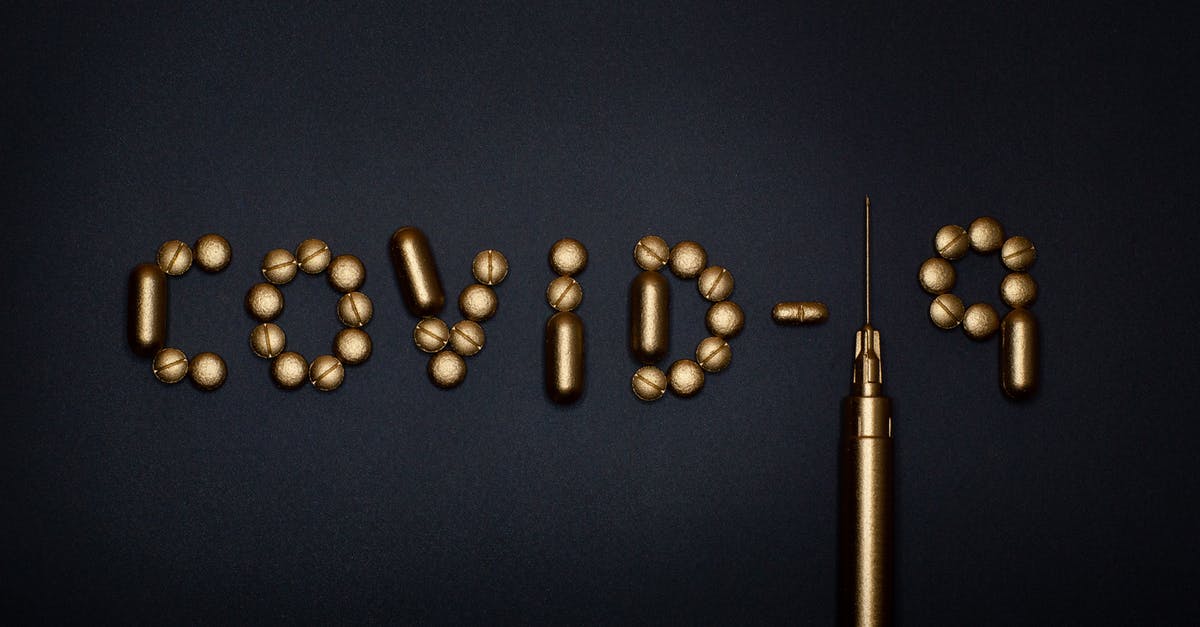 Rwanda: Yellow fever vaccination required? - Pills on Blue Background Rwanda: Yellow fever vaccination required? - Pills on Blue Background