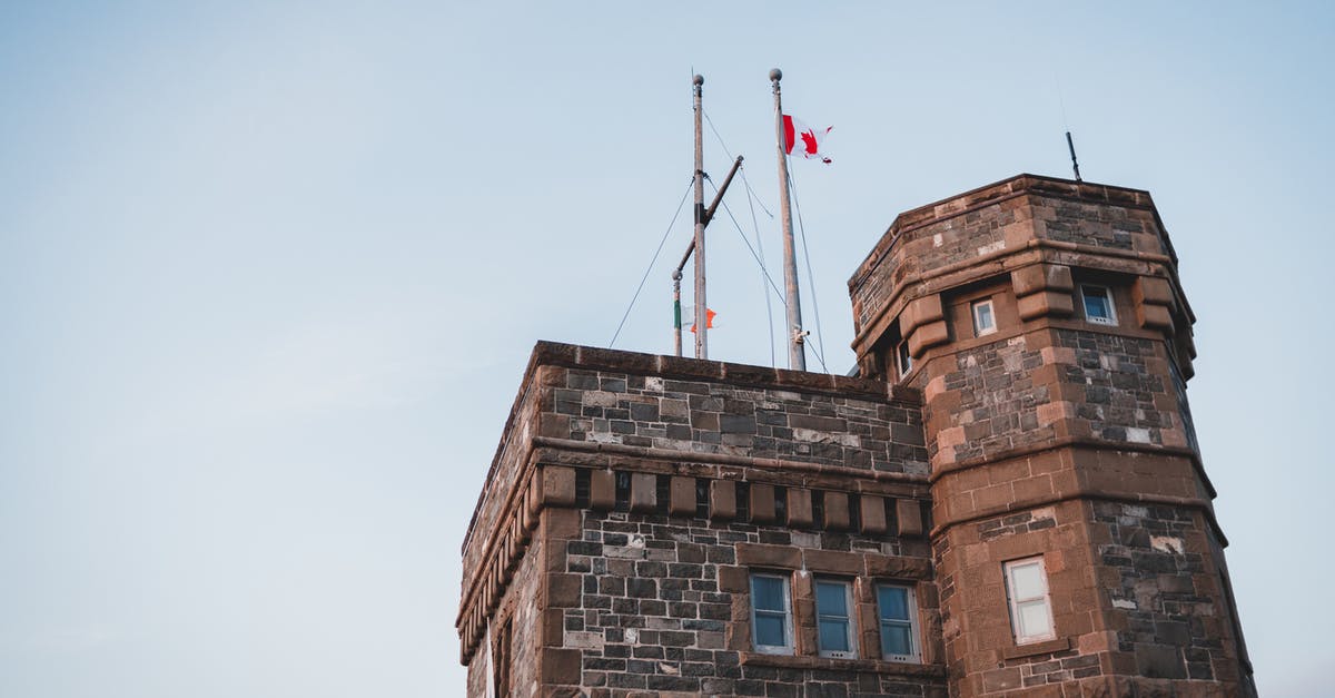 SA national with CoPR travelling from Canada to SA via UK [duplicate] - Facade of Gothic styled tower with flag on roof