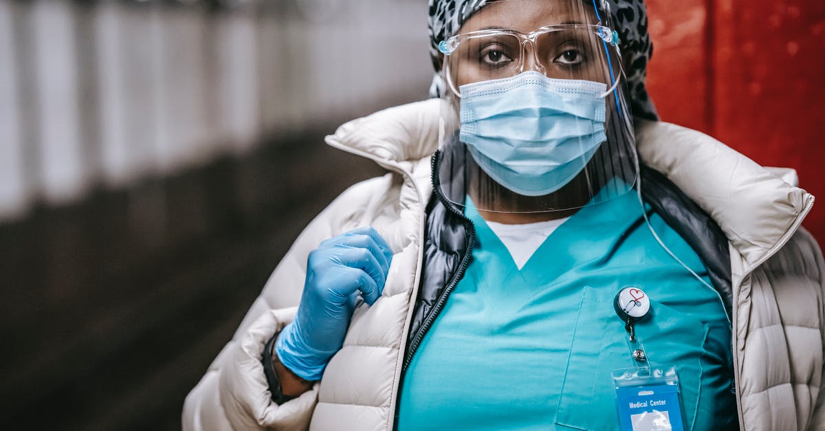 Safe to have flight stops at Istanbul? - Crop serious black nurse in mask standing on train platform Safe to have flight stops at Istanbul? - Crop serious black nurse in mask standing on train platform