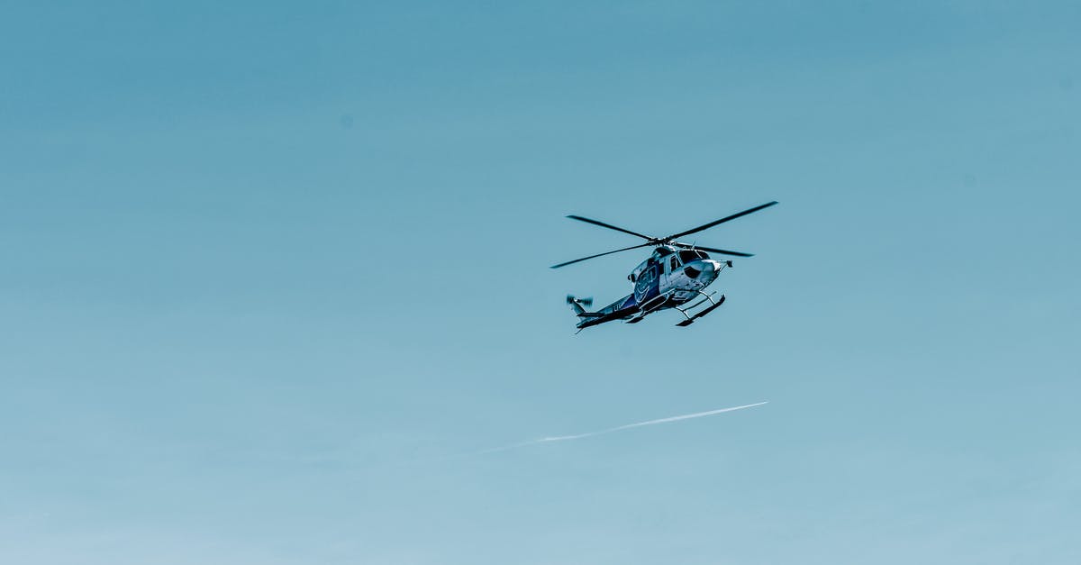 Safety considerations for a space flight - From below of modern helicopter flying in cloudless blue sky on sunny day Safety considerations for a space flight - From below of modern helicopter flying in cloudless blue sky on sunny day