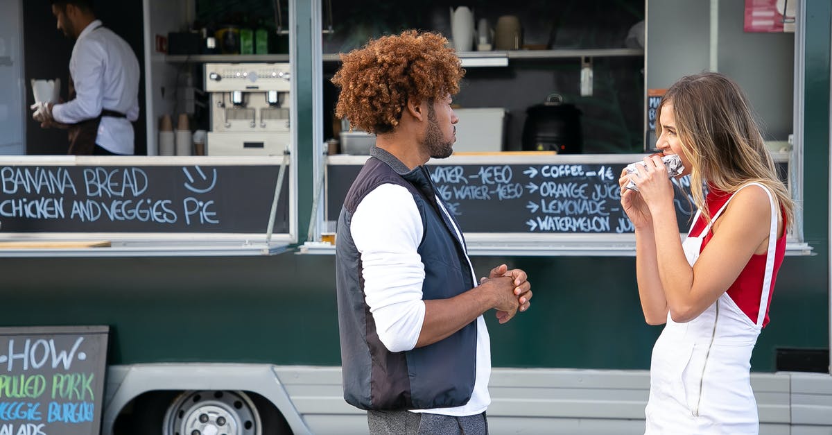 Sandwich alternatives for city trips - Young diverse couple eating takeaway sandwich while standing near food truck Sandwich alternatives for city trips - Young diverse couple eating takeaway sandwich while standing near food truck