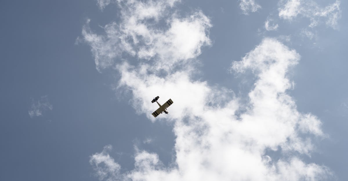 Scheduled Ryanair flights from Zaventem moved to Charleroi? - From below of airplane with wings flying high in air on sky with white clouds during flight on sunny day Scheduled Ryanair flights from Zaventem moved to Charleroi? - From below of airplane with wings flying high in air on sky with white clouds during flight on sunny day