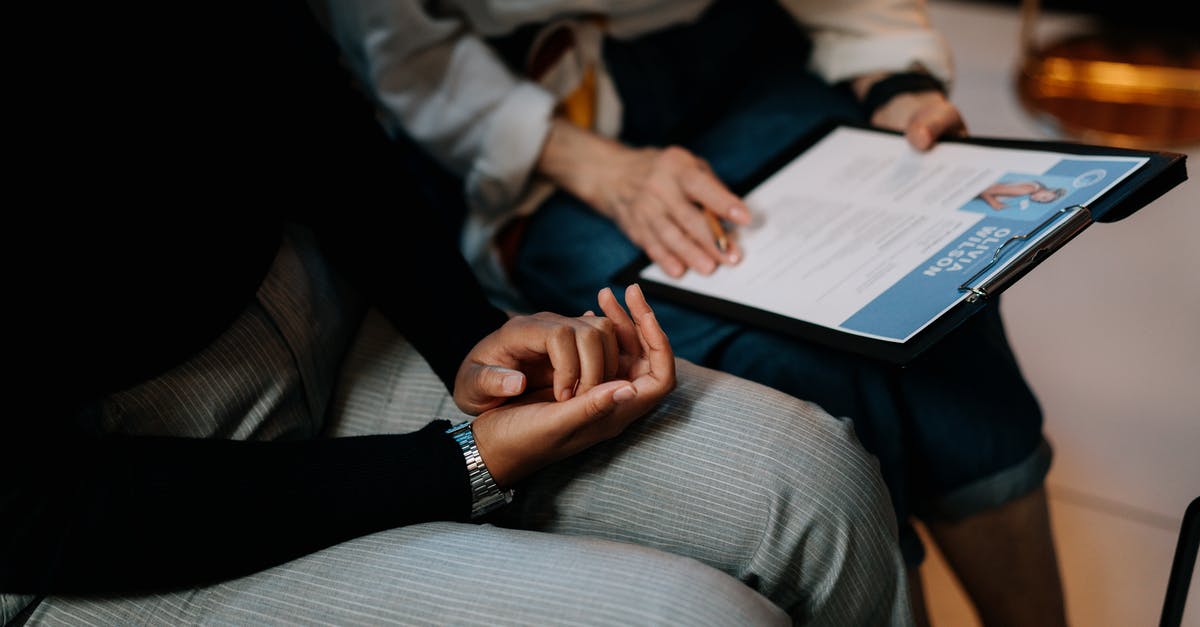 Schengen business visa - when working for 2 companies, do I provide documents for both companies? - Person in White Long Sleeve Shirt Holding a Clipboard with Resume