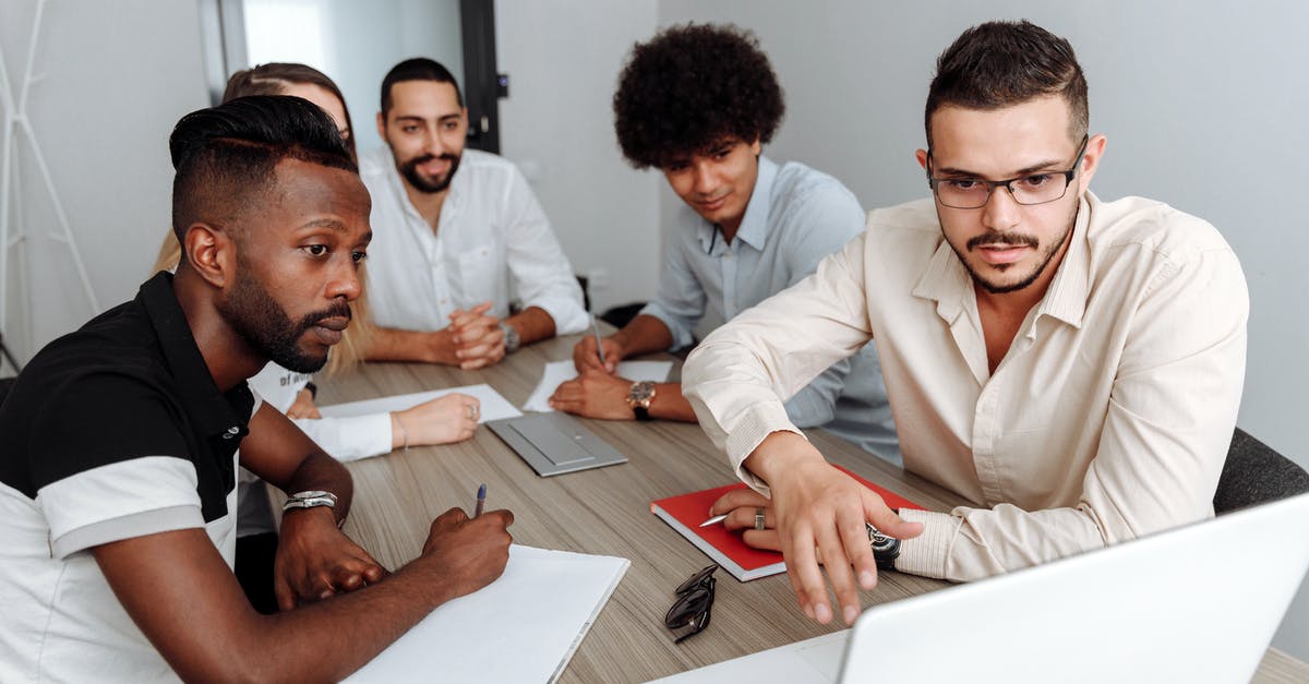 Schengen business visa - when working for 2 companies, do I provide documents for both companies? - Group of People in a Meeting Looking at a Laptop Screen
