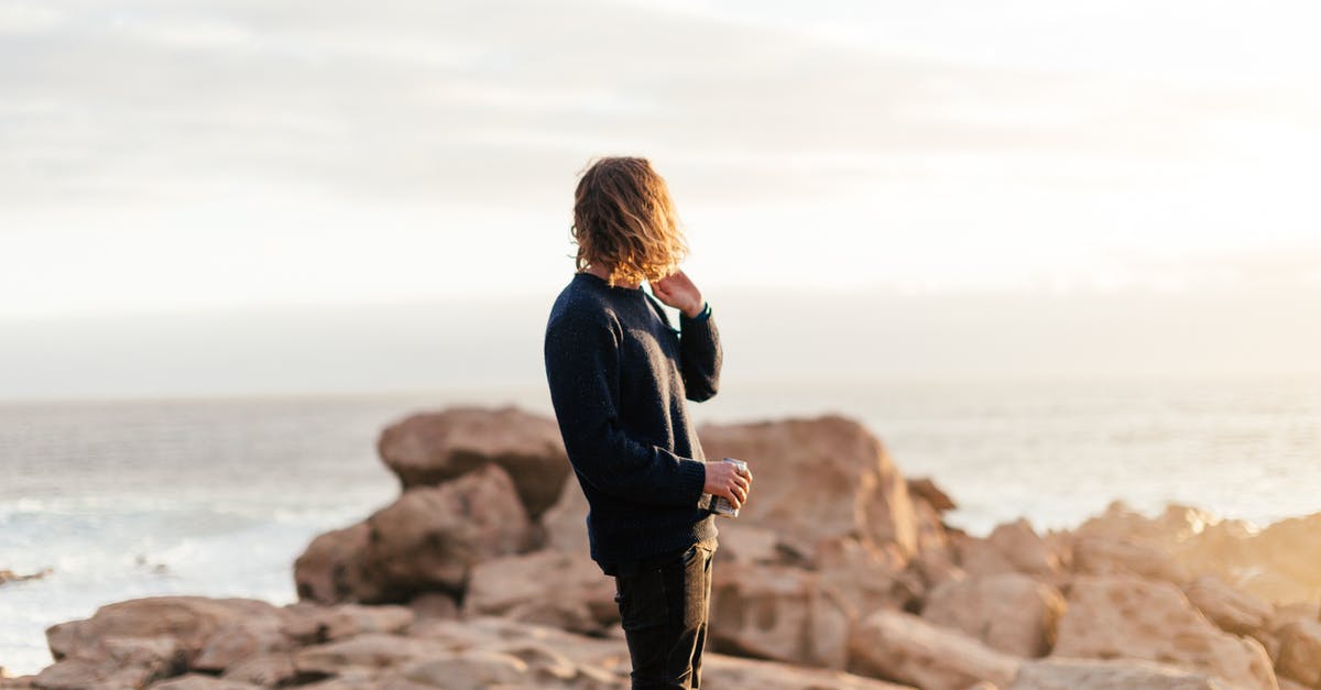 Schengen tourist visa refused. Can I appeal for reconsideration? - Side view of anonymous male traveler with can of beverage admiring ocean from rough rocks under shiny sky in evening Schengen tourist visa refused. Can I appeal for reconsideration? - Side view of anonymous male traveler with can of beverage admiring ocean from rough rocks under shiny sky in evening