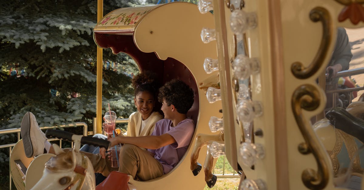 Schengen Visa - Date of Departure after first intended stay - Teenage couple sitting in carousel seat smiling and talking to each other Schengen Visa - Date of Departure after first intended stay - Teenage couple sitting in carousel seat smiling and talking to each other