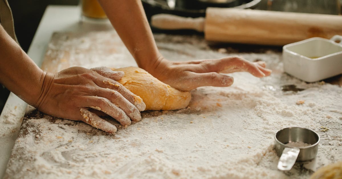 Schengen visa for housewife - Woman making pastry on table with flour Schengen visa for housewife - Woman making pastry on table with flour