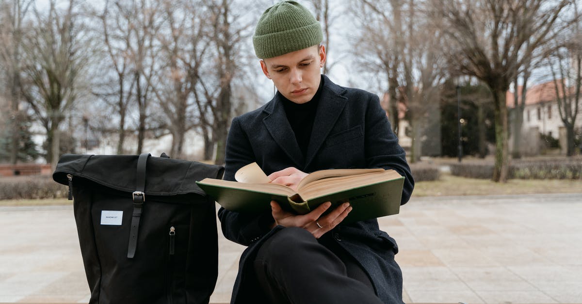 Schengen visa for international student in UK - A Man in Black Coat Sitting on a Bench Reading Book Schengen visa for international student in UK - A Man in Black Coat Sitting on a Bench Reading Book