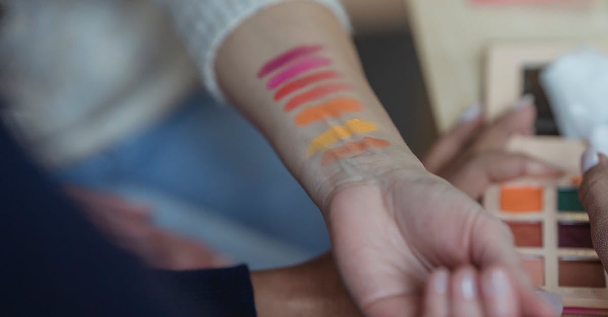 Schengen visa for Iranian in New Zealand - where to apply? - Faceless women applying multicolored eyeshadows on wrist for testing Schengen visa for Iranian in New Zealand - where to apply? - Faceless women applying multicolored eyeshadows on wrist for testing
