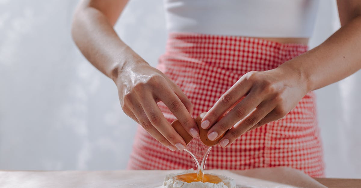 Schengen visa holder issued by the Italian embassy - getting into Romania via Frankfurt? - Unrecognizable Female Hands Breaking Egg into Mound of Flour