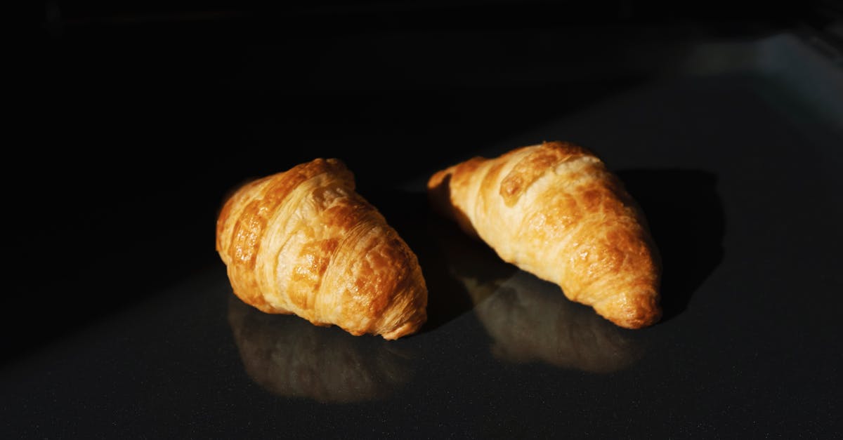 Schengen visa refused two times by the French consulate, how to appeal? [closed] - Pair of fresh yummy croissants on black glass surface