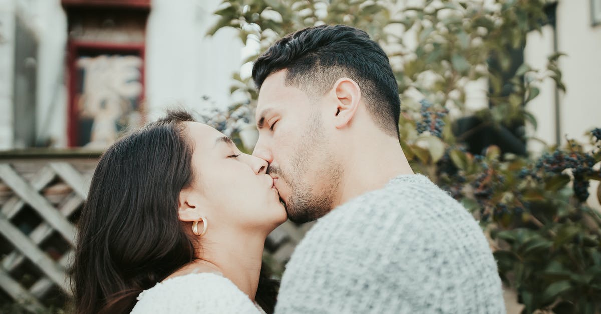Schengen visa to Austria - start date on passport is a day after the arrival date [closed] - Side view of young couple in casual clothes standing in street together in summer day near green plants and building on background and kissing each other tenderly