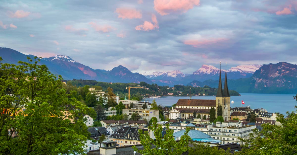 Schengen visa to travel from Germany to Switzerland - Medieval European town on shore in mountains Schengen visa to travel from Germany to Switzerland - Medieval European town on shore in mountains
