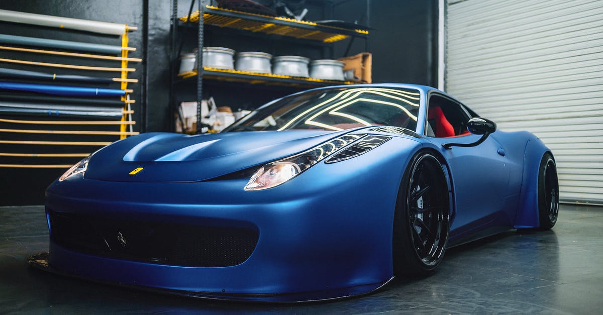 Search engine of Italian buses - Luxury coupe car with glowing headlights in workshop Search engine of Italian buses - Luxury coupe car with glowing headlights in workshop