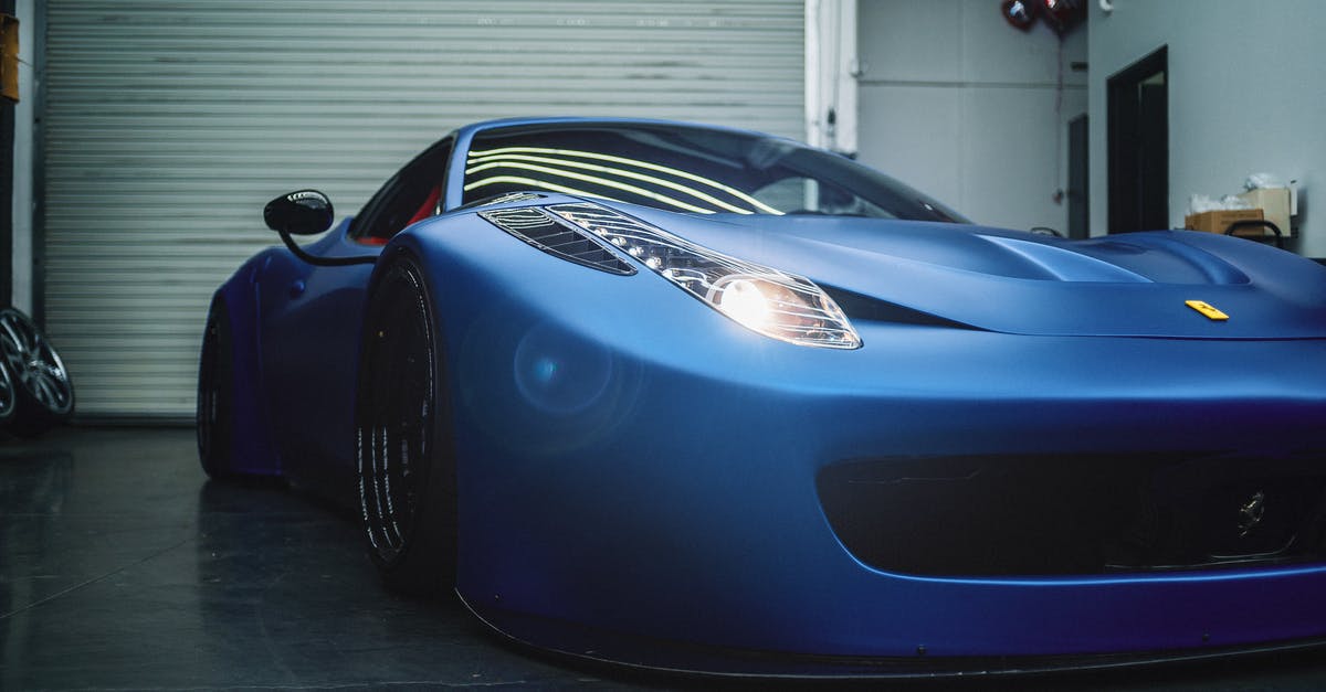 Search engine of Italian buses - Luxury low electric blue sports car with glowing headlights parked in grungy workshop Search engine of Italian buses - Luxury low electric blue sports car with glowing headlights parked in grungy workshop