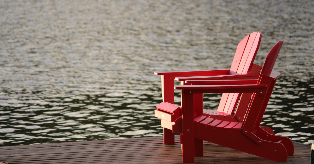 Seat Assignment on Via Rail's The Ocean - Red Wooden Lounge Chair on Brown Boardwalk Near Body of Water during Daytime Seat Assignment on Via Rail's The Ocean - Red Wooden Lounge Chair on Brown Boardwalk Near Body of Water during Daytime