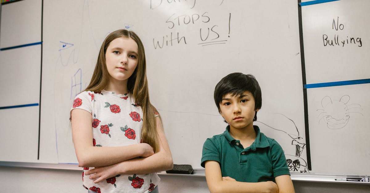 Secondary school in the US just for one month - Two Kids Standing by the White Board Secondary school in the US just for one month - Two Kids Standing by the White Board