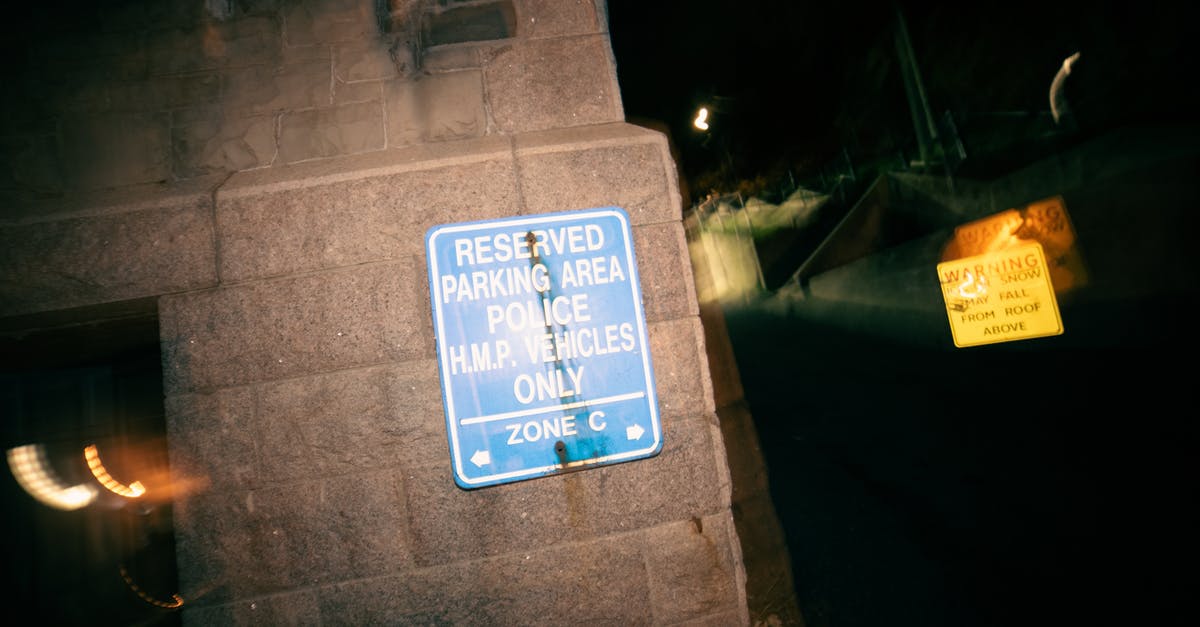 Secure long-term parking in Johannesburg - Signboard restricting parking for cars on reserved area for police vehicles at night Secure long-term parking in Johannesburg - Signboard restricting parking for cars on reserved area for police vehicles at night