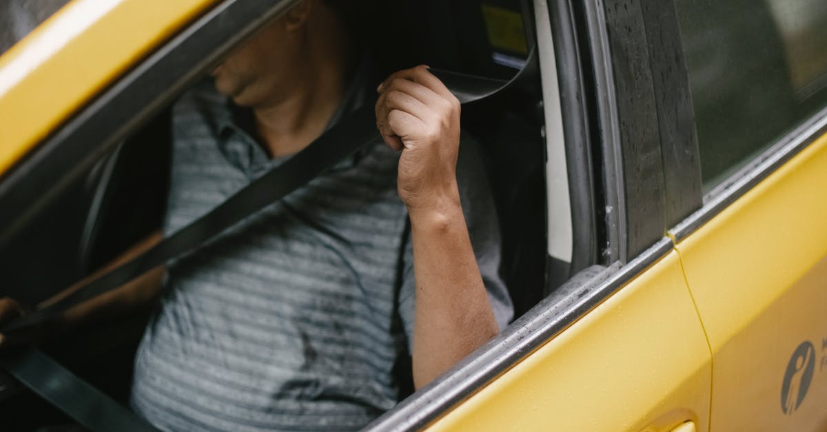 Secure long-term parking in Johannesburg - Unrecognizable male driver sitting in cab and fastening seat belt Secure long-term parking in Johannesburg - Unrecognizable male driver sitting in cab and fastening seat belt