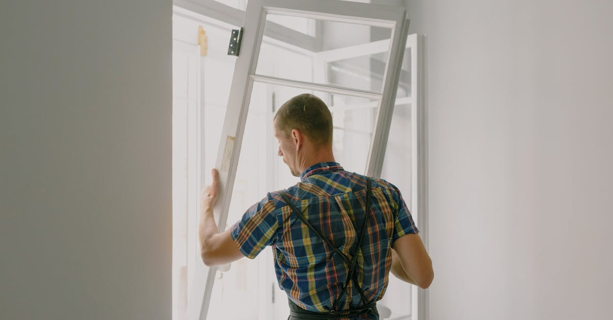 Sending Passport for Canada Visa Process to New York - Unrecognizable workman installing window in house during renovation process Sending Passport for Canada Visa Process to New York - Unrecognizable workman installing window in house during renovation process
