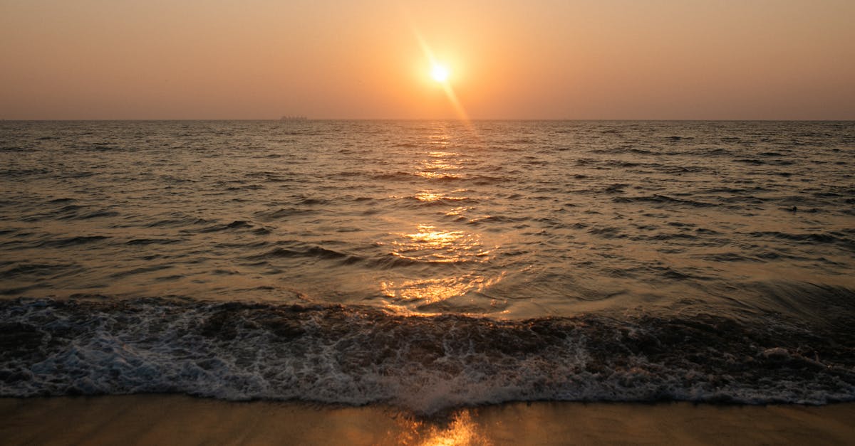 Setting up a tent on a beach in Greece - Ocean Waves Crashing on Shore during Sunset Setting up a tent on a beach in Greece - Ocean Waves Crashing on Shore during Sunset